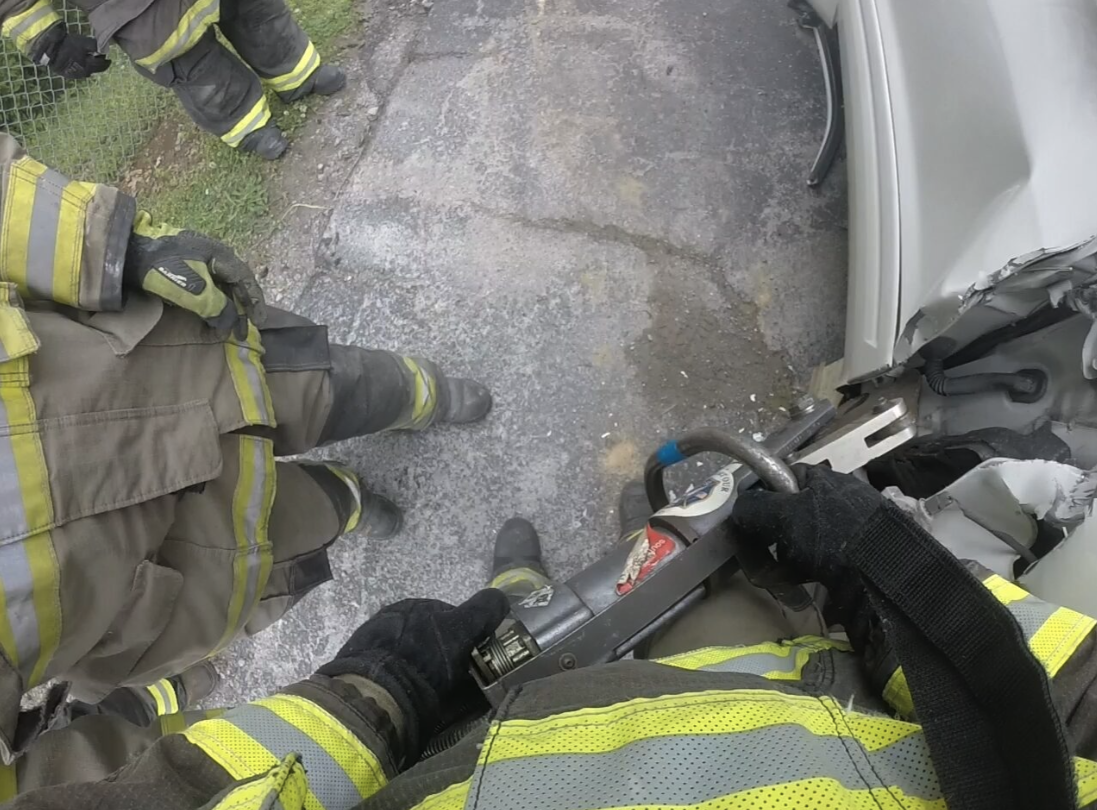 Firefighters using rescue tools during a vehicle incident