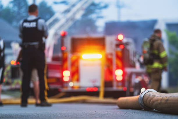 Police and fire personnel responding near a fire engine